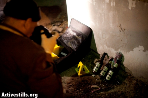 Forensic workers take pictures of unused Molotov cocktails 